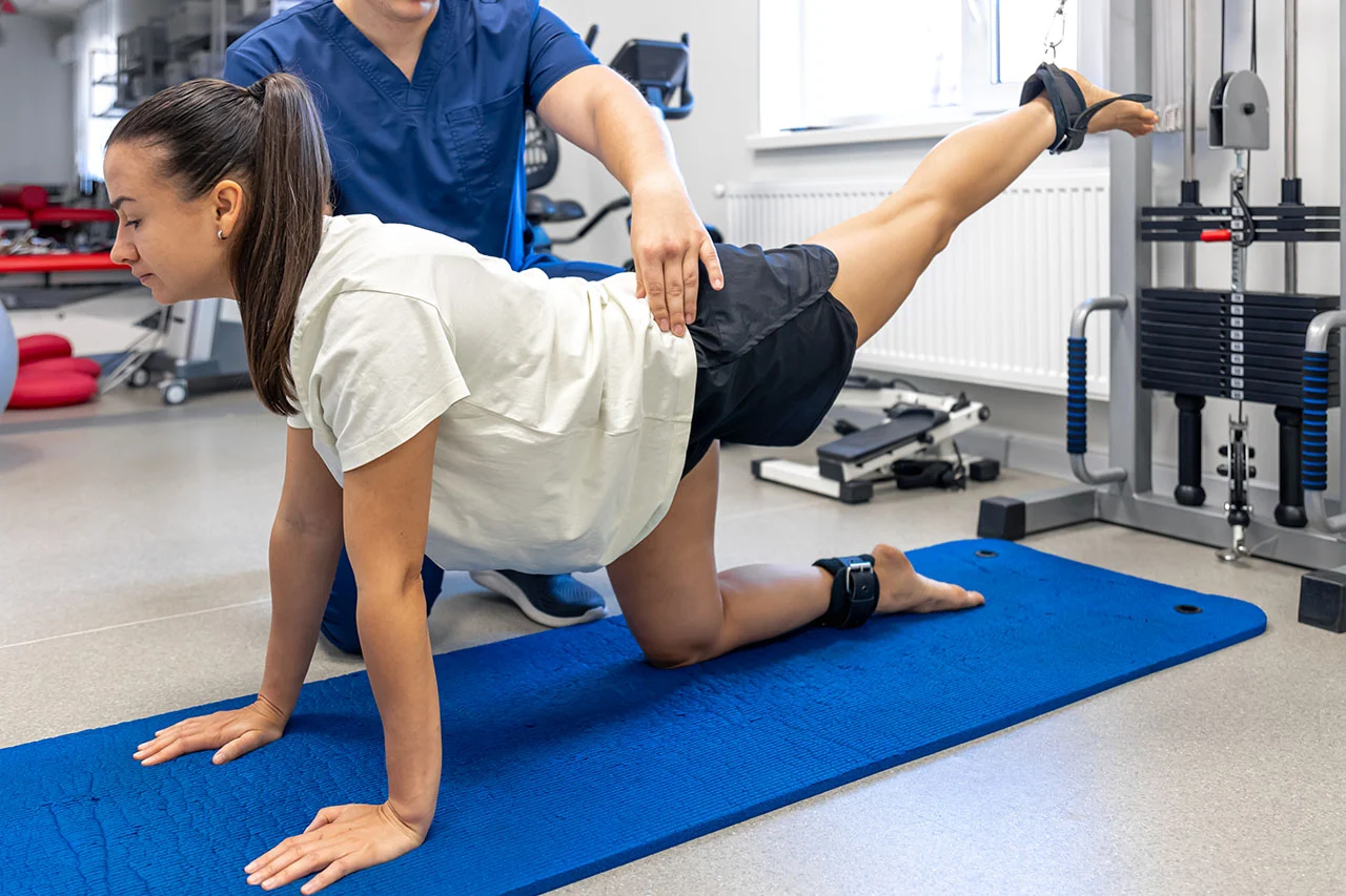 Patient performing core strengthening and exercise rehabilitation for back pain recovery at Rally Point Health and Rehab in Markham ON