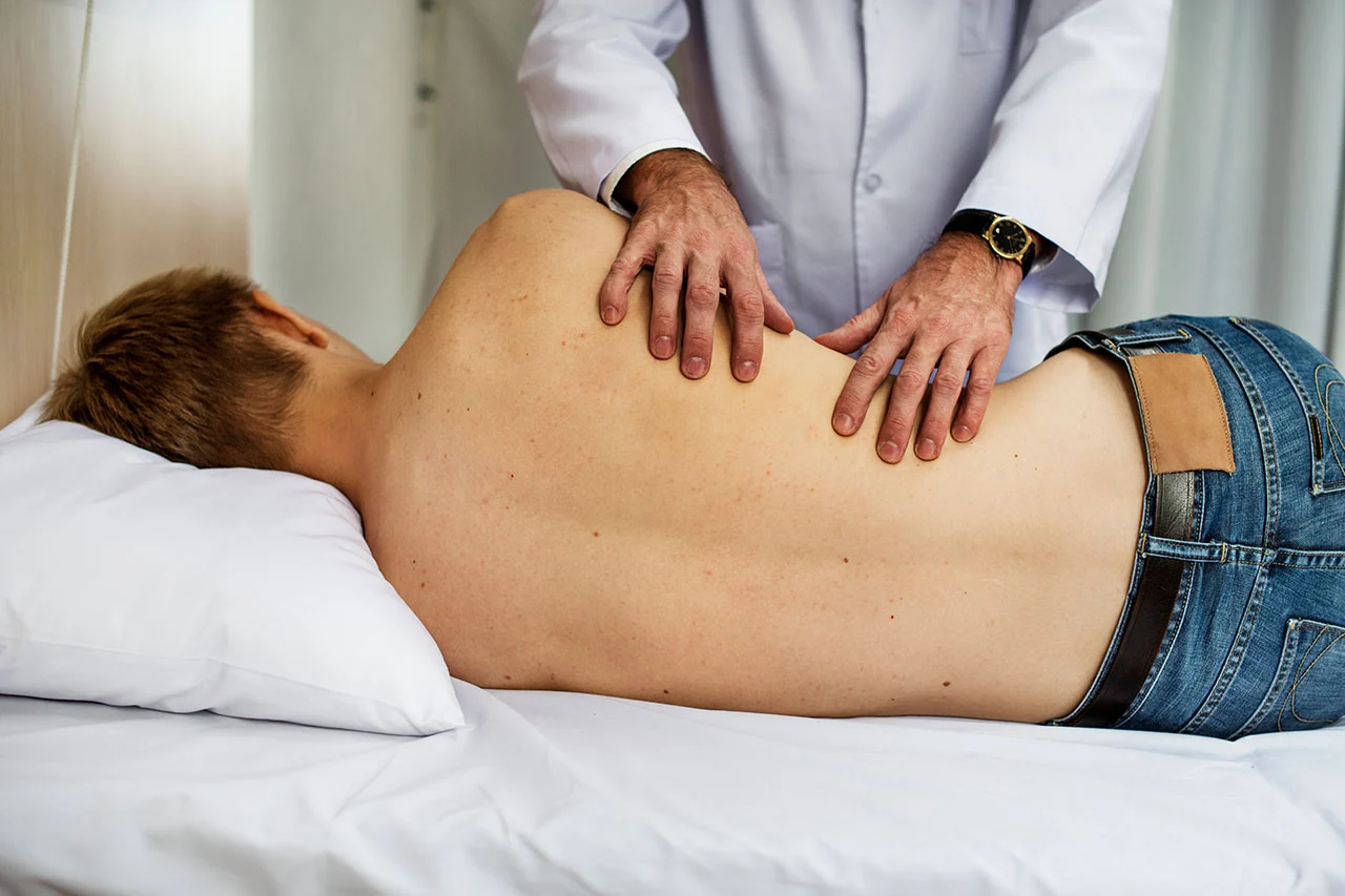 Chiropractor performing a spinal adjustment at Rally Point Health and Rehab in Markham ON